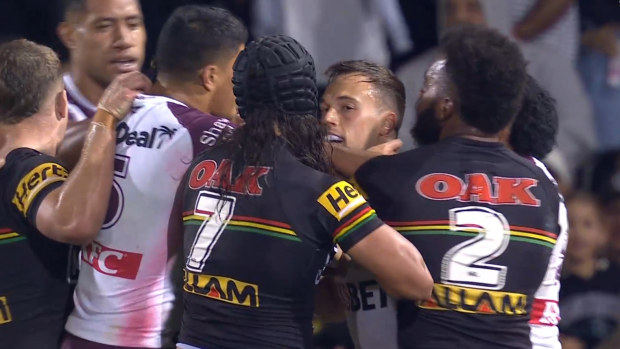 Luke Brooks and Jarome Luai separated by teams after a heated exchange.