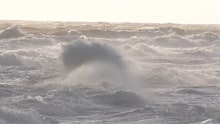 South Australians have been warned about a powerful storm surge that is smashing the state's coast - and drawing plenty of onlookers while it's at it.