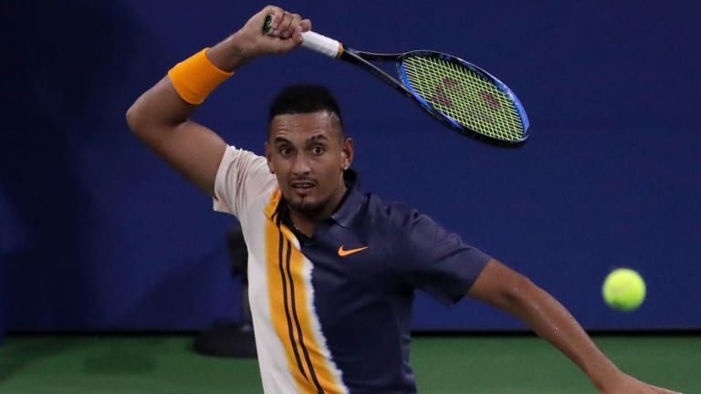 Nick Kyrgios returns a shot to Radu Albot.