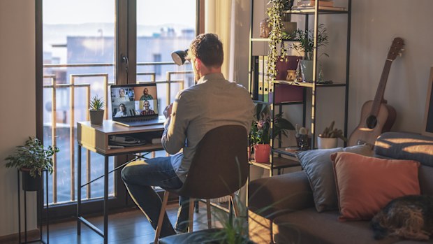 Shot of business man having a video call on a laptop in his home office.
