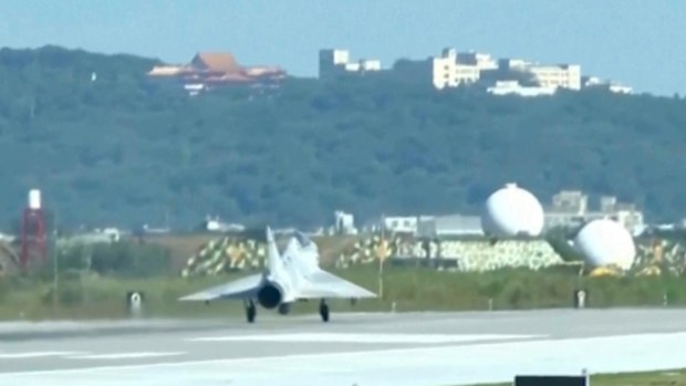In this image taken off video, a Taiwan fighter jet lands at the Hsinchu Airbase in Taiwan on Monday, Dec. 29, 2025. (AP Photo/Wu Taijing)