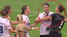 Isobel Nino grabs Emily Gielnik by the throat.