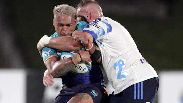 D'Angelo Leuila of Moana Pasifika is tackled by Captain Luke Romano of the Blues.