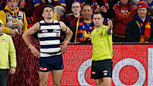 Mark OConnor of the Cats is seen as Brent Wallace, AFL Field Umpire awards a free kick to Cam Rayner.