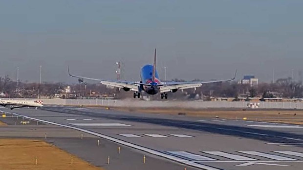 In this screengrab made from video, a Southwest Airlines plane and a private jet are seen in a near miss incident at Chicago's Midway International Airport on February 25.