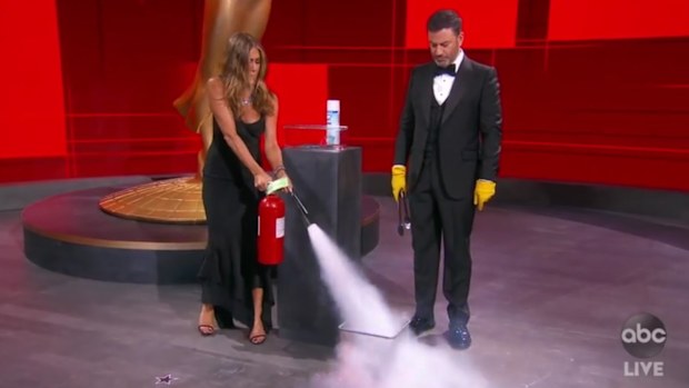 Jimmy Kimmel and Jennifer Aniston sanitise Emmys envelope.