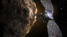 This illustration shows the Lucy spacecraft passing one of the Trojan Asteroids near Jupiter.