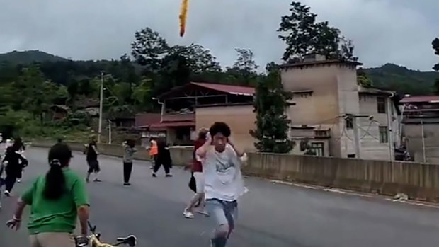 A screengrab taken from video shows suspected Chinese rocket debris falling over Xianqiao Village, Xinba Town, Guizhou Province in China, following a launch.
