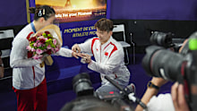 China's Liu Yuchen proposes to teammate Huang Ya Qiong after she won her mixed doubles badminton final match at the 2024 Summer Olympics, Friday, Aug. 2, 2024, in Paris, France. (AP Photo/Dita Alangkara)