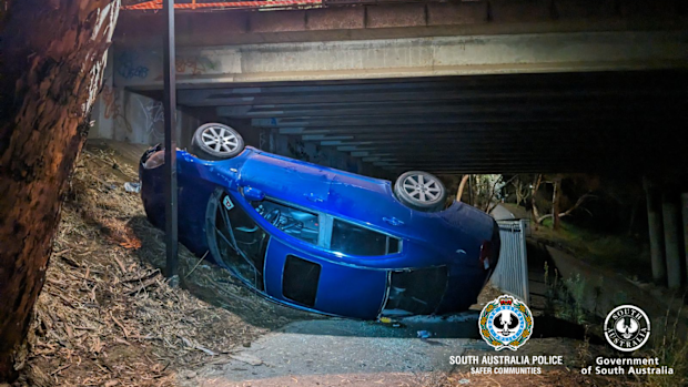 A teenager has escaped serious injury after his car crashed through the barrier of an overpass bridge and dropped five metres in Adelaide's north-east.