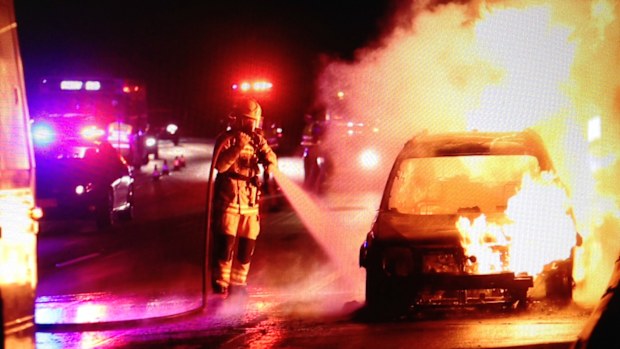 Firefighters working to extinguish the car fire on the M1 northbound. (Supplied, Robert Eldridge)