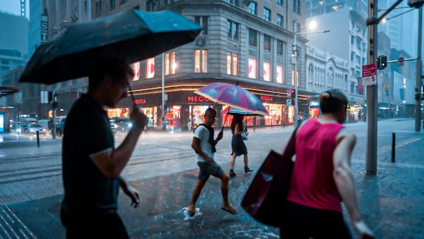 Heavy rain from storms sweep into the CBD with many caught out. 