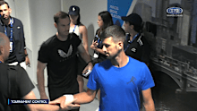 Andy Murray carries Novak Djokovic's racquets through the players only area at Melbourne Park.
