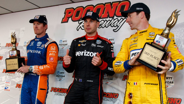 Will Power celebrates his victory on the podium.