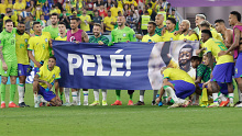 The Brazil squad with a banner honouring Pele.