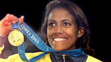 SYDNEY, AUSTRALIA - SEPTEMBER 25:  (FILE PHOTO)  Cathy Freeman of Australia celebrates with her Gold medal after winning the Women's 400m final at the Sydney 2000 Olympic Games, Sydney Australia.  Freeman announced July 15, 2003 her intention to retire from athletics. She was scheduled to compete in next month's World Athletics Championships, but has decided to bring her career to a close.  (Photo by Hamish Blair/Getty Images)