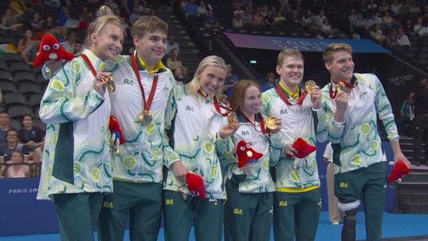 Australia's mixed 4x100m medley relay team stand atop the podium.