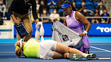 Naomi Osaka puts a towel over Daria Saville after the Australian's injury. 