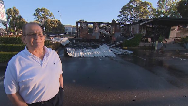The owner of an Italian restaurant that burned down standing in front of what remains of his business. 