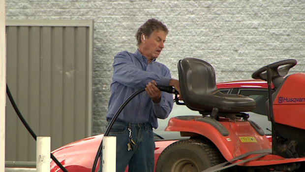 Man filling up tractor