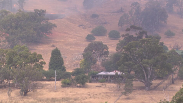 The fire could be seen burning slowly across dry grassland, dangerously close to homesteads.