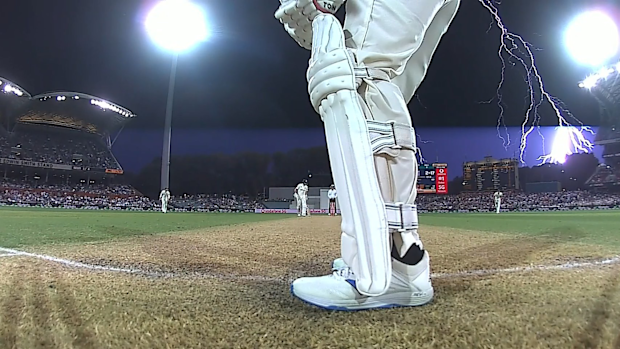 A giant bolt of lightning strikes outside of the Adelaide Oval, halting play.