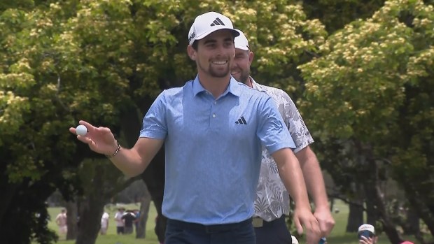 Joaquin Niemann acknowledges the  crowd after hitting a hole in one on the par-3 fourth hole during the final round of the Australian PGA Championship at Royal Queensland.