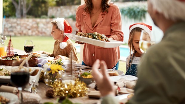 Cropped shot of a happy family having Christmas lunch together
