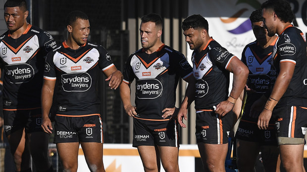 The Tigers look on after a Sharks try.