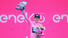 Jai Hindley celebrates at the podium as overall race winner of the Giro d'Italia.