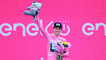Jai Hindley celebrates at the podium as overall race winner of the Giro d'Italia.