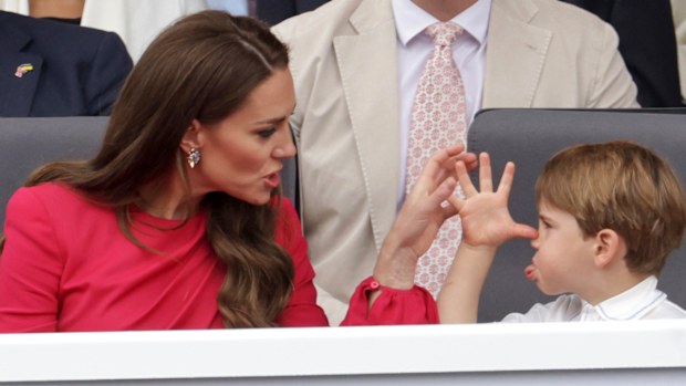 Kate, Duchess of Cambridge, left speaks with Prince Louis, during the Platinum Jubilee Pageant, in London, Sunday June 5, 2022, on the last of four days of celebrations to mark the Platinum Jubilee.  