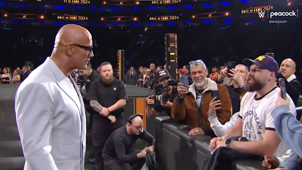 Dwayne 'The Rock' Johnson stopped to confront a fan during a WWE event.