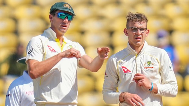 Australia's captain Pat Cummins, left, adjusts fielding as Todd Murphy watches during the third day of the first cricket test match between India and Australia in Nagpur, India, Saturday, Feb. 11, 2023. (AP Photo/Rafiq Maqbool)