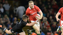 Welsh player Johnny McNicholl is tackled by New Zealand's Brad Weber during the Spring Tour in 2021.