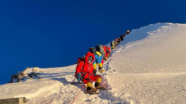 	Mountaineers as they climb during their ascend to summit Mount Everest in May 2021.
