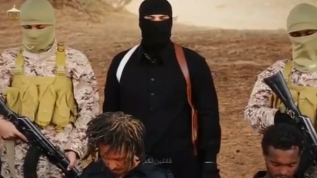 An ISIL execution pictured with Ethiopian Christians in a video released by the terrorist group. (Supplied)