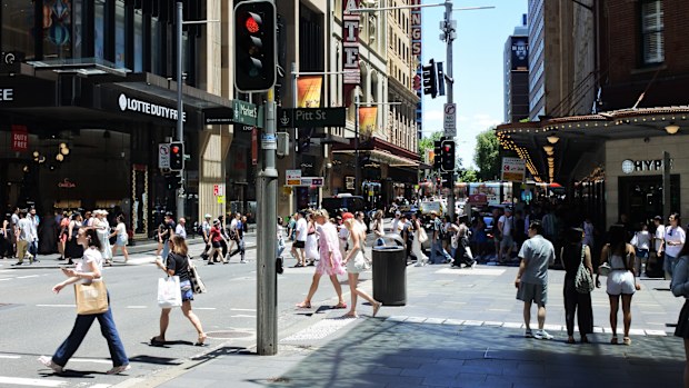SYDNEY - DEC 29 2024:Pedestrians crossing a street in Sydney central business district in Sydney the capital city of New South Wales, Australia.