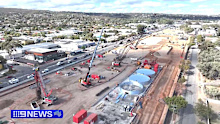 The $15.4 billion project aims to eliminate 21 sets of traffic lights, potentially reducing peak hour travel times by up to 40 minutes.