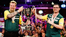 Simon Whitlock and Damon Heta with their World Cup of Darts trophy.