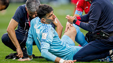 Alireza Beiranvand is tended to by medical staff. 