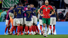 Sofyan Amrabat stands dejected as France celebrate.