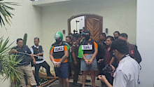 The accused killers were forced to reenact the alleged shooting