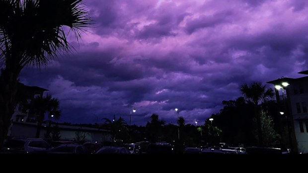 Amy Pope-Latham says she watched on Wednesday as the sky outside her Jacksonville apartment transformed from gray clouds to a burnt orange to a "beautiful violet that continued to become even more vibrant as minutes passed."