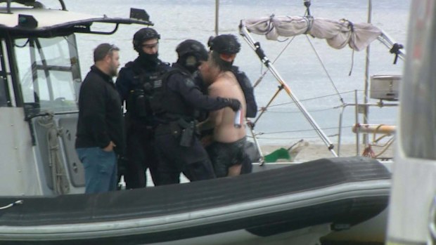 A man has been arrested after crashing an allegedly stolen ute into a house and trying to swim away from police on Queensland's Sunshine Coast.