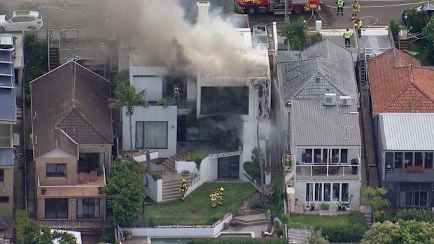 Firefighters have rushed to a multi-million dollar house in Sydney after it caught fire on Boxing Day.Flames were seen coming from the three-level home on Kent Street in Waverley, near Bondi.