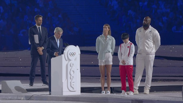 Emma McKeon alongside IOC president Thomas Bach during his closing ceremony speech.