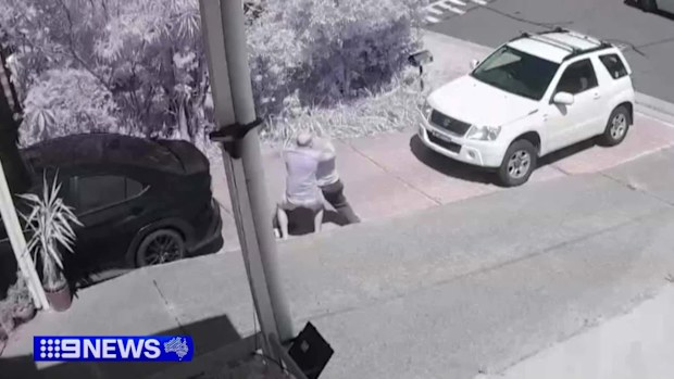 A man is behind bars accused of murdering his neighbour in a deadly end to what neighbours claim has been a long-running and bitter conflict.The pair allegedly squared off over a large gum tree that towers over their homes in Sydney.
CCTV appears to show Michael Wickham, 60, heading in towards the Dargie Street house in Mount Pritchard after steering his Suzuki into his neighbour's driveway.