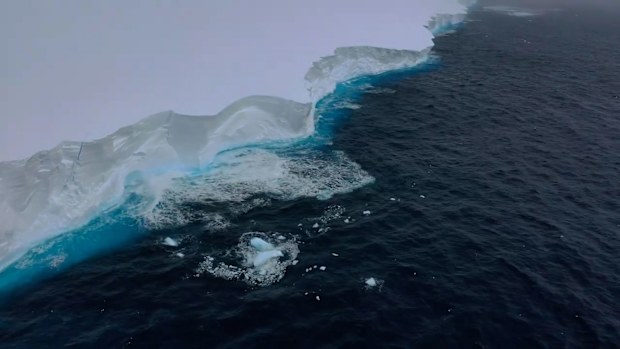 New footage of a mammoth iceberg floating near Antarctica which looms taller than Australia's tallest building has been captured by scientists.