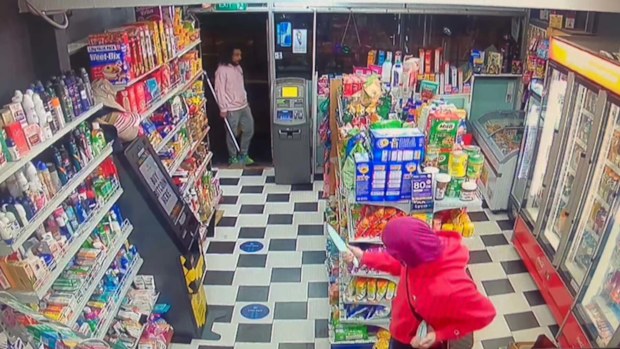 CCTV from Aruma Grocery on the next street shows a man in a mask wielding a large knife.
